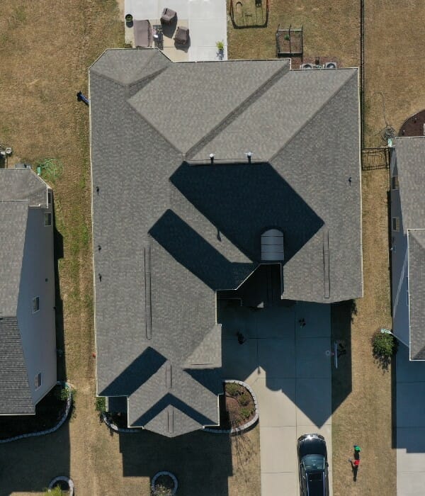 Straight down view of a large residential home with shingle roof